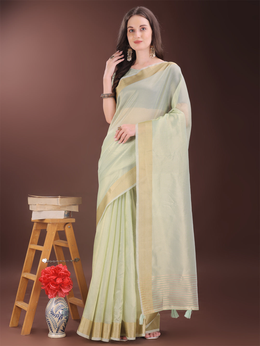 Light green organza saree with elegant golden zari border