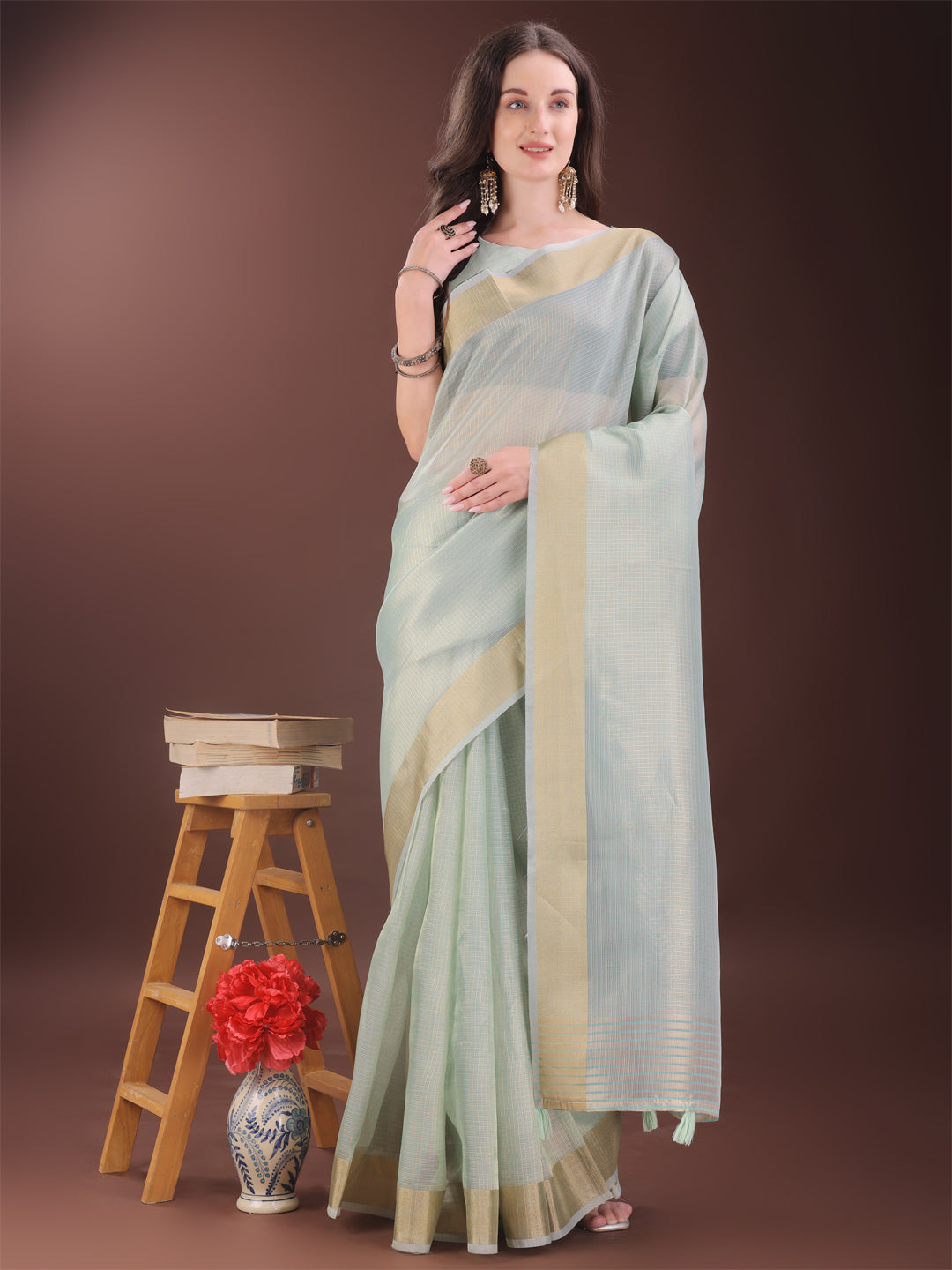 Sky Blue organza saree featuring a luxurious golden zari border and matching blouse piece