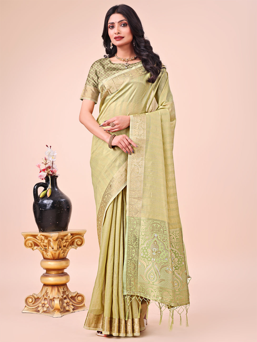 Light green organza saree with detailed traditional zari border