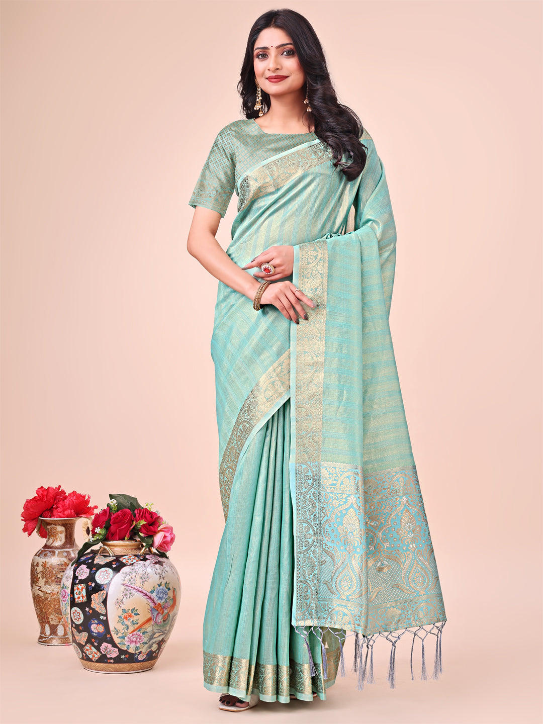 Deep teal organza saree with ornate zari woven borders and motifs