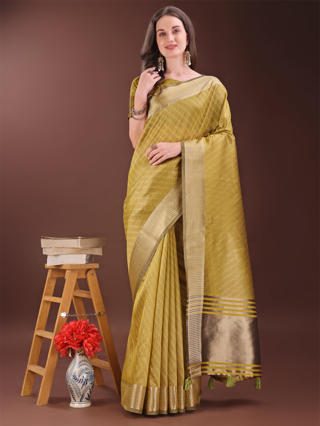 Mustard organza saree with elegant gold zari border draped elegantly.