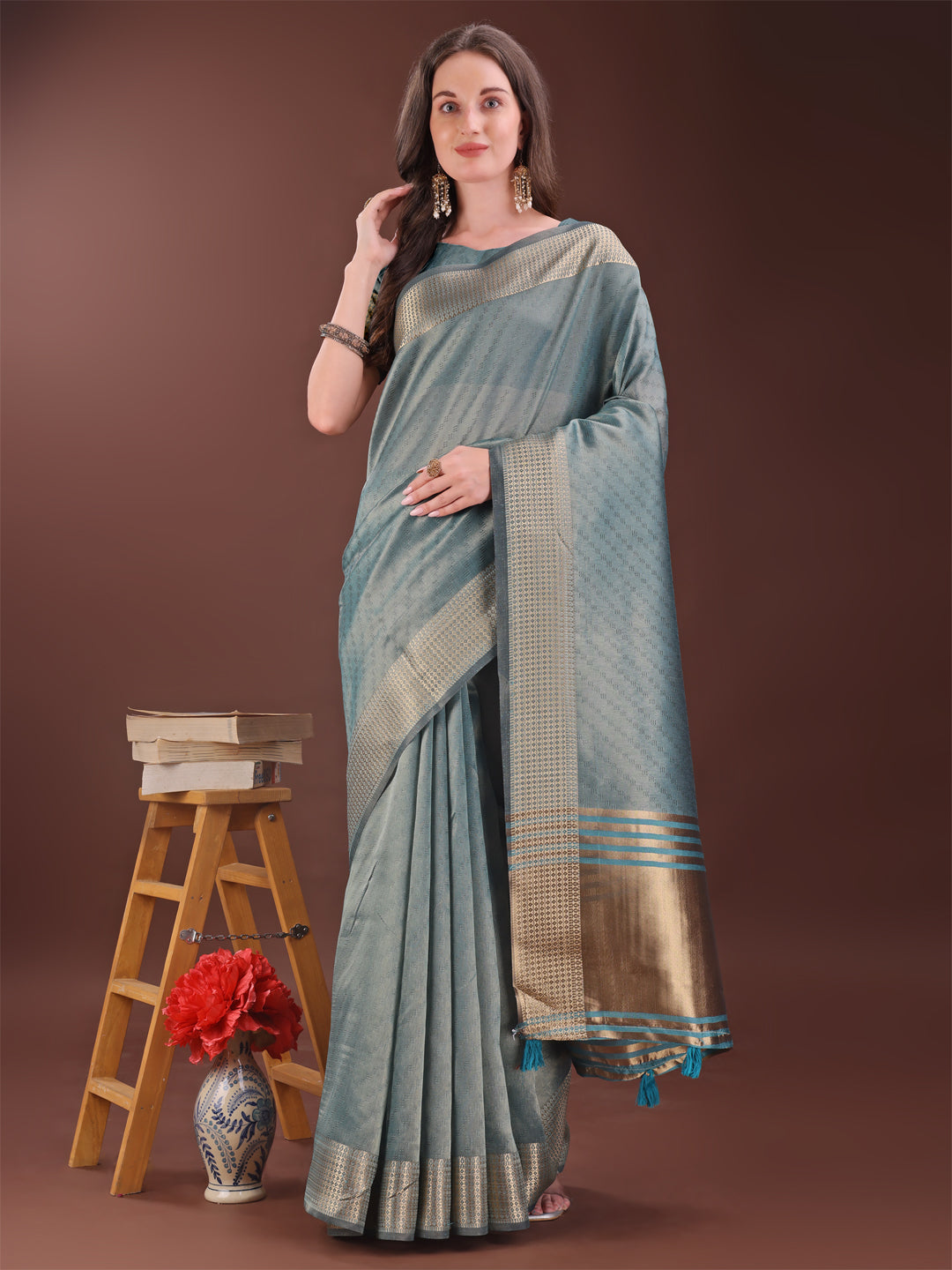 Sea green organza saree with rich golden zari border and pallu
