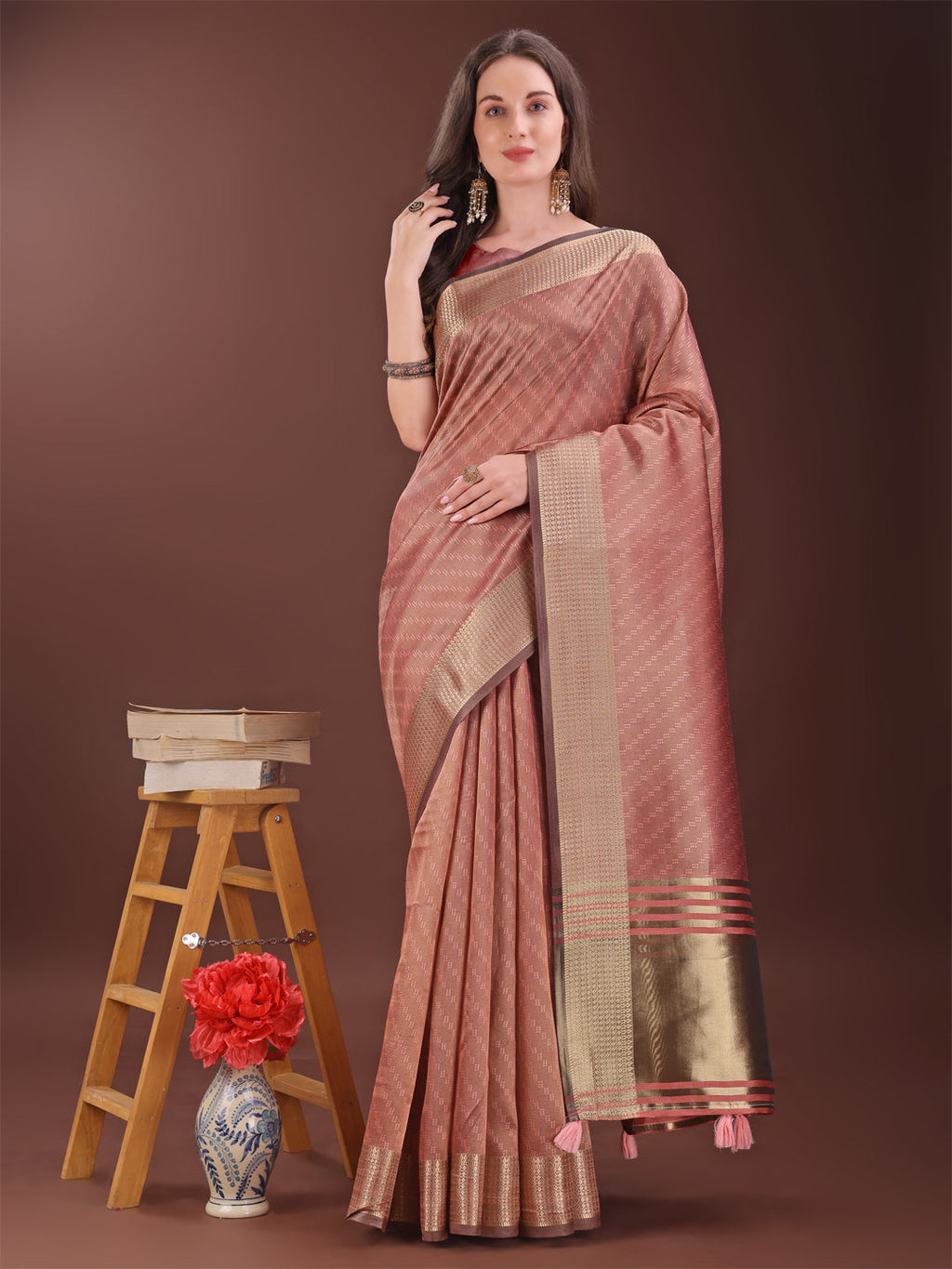 Elegant peach organza saree with a prominent golden zari border