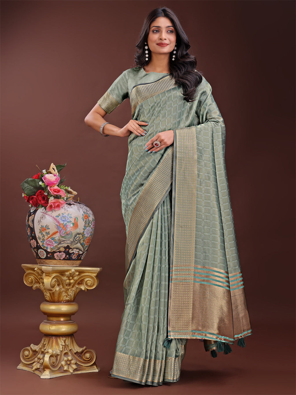 Light green organza saree with a detailed golden zari border and matching blouse