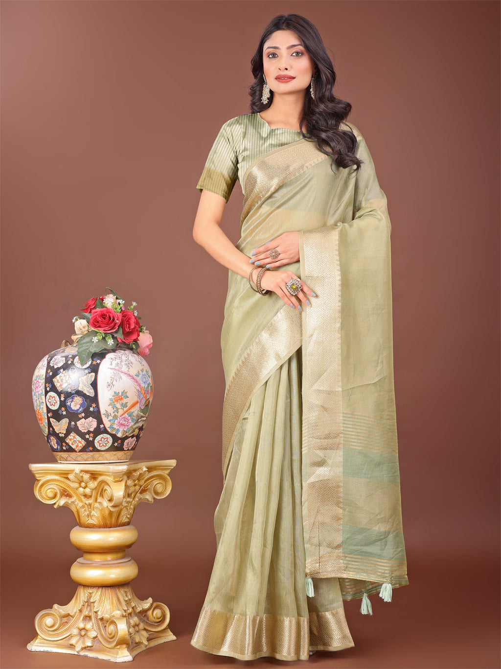 Light Green linen saree featuring a golden zari border and rich pallu