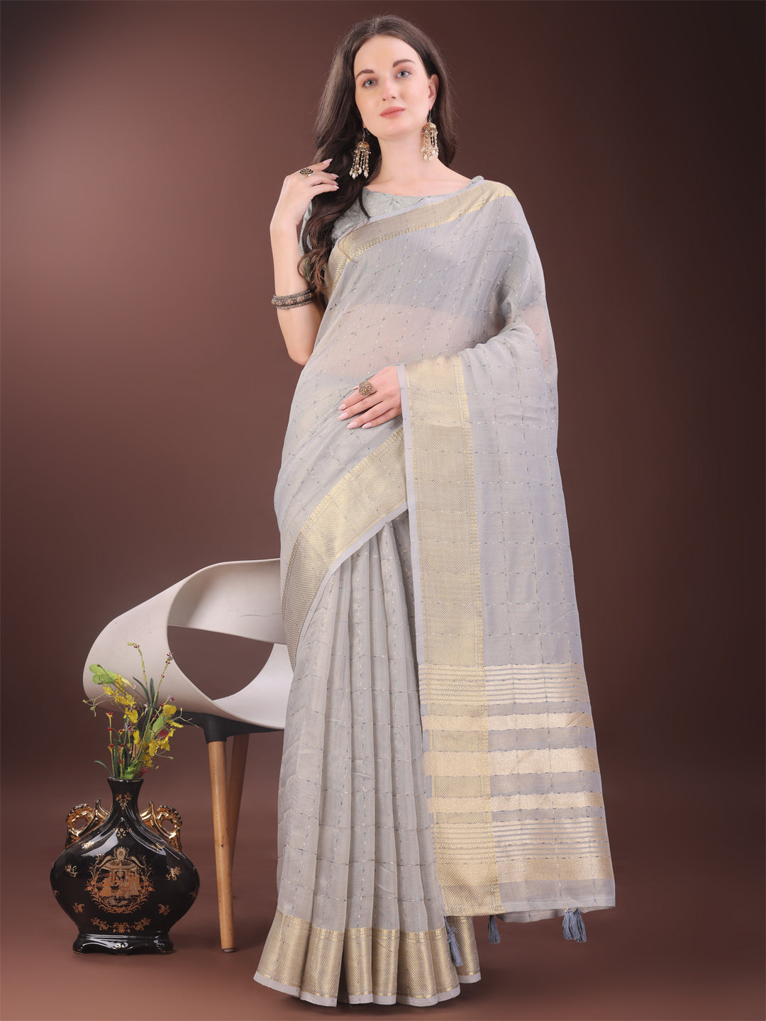 Elegant grey organza saree with golden zari border and designer tassels