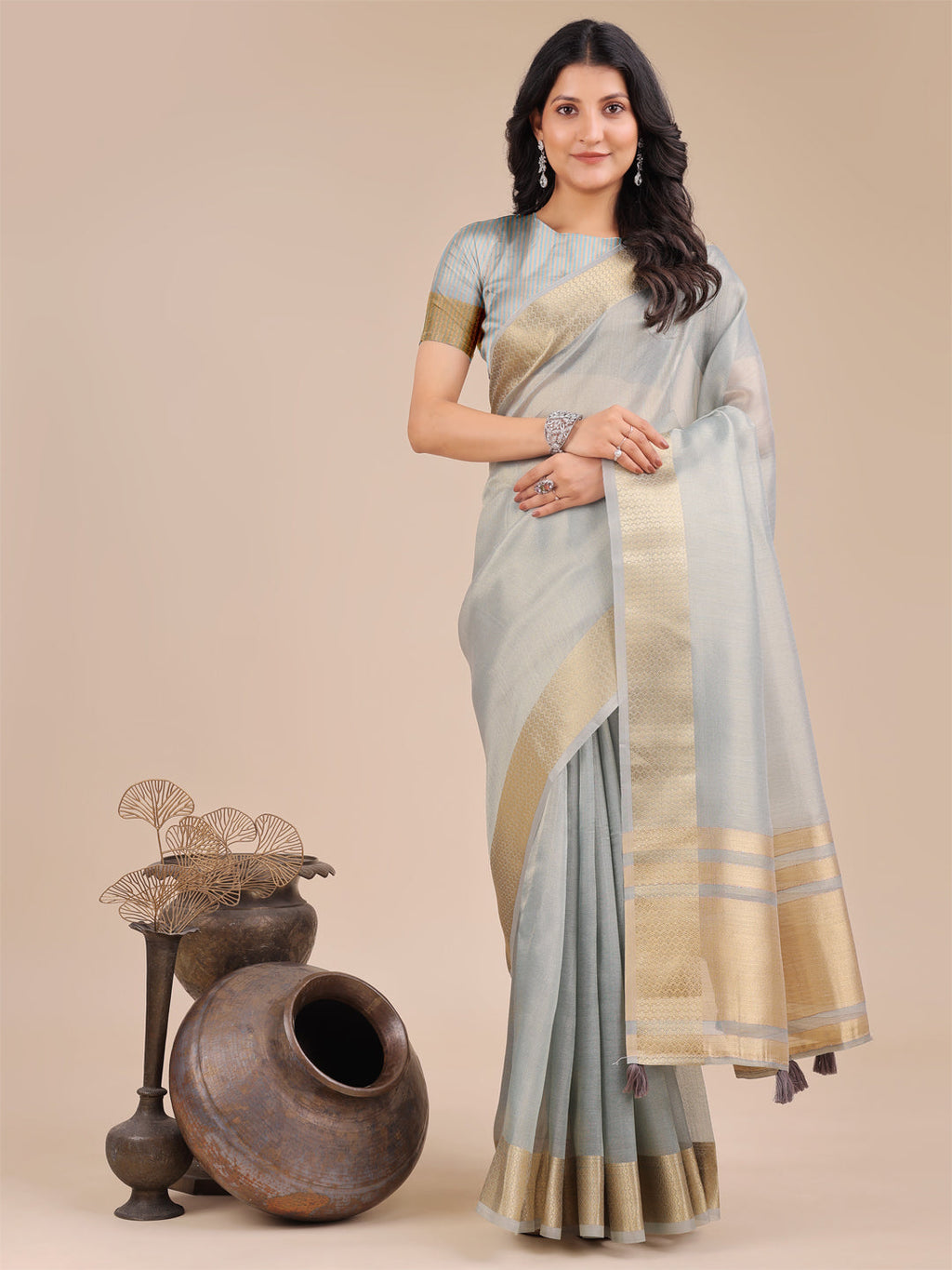 Sky blue organza saree with zari work and tassel details