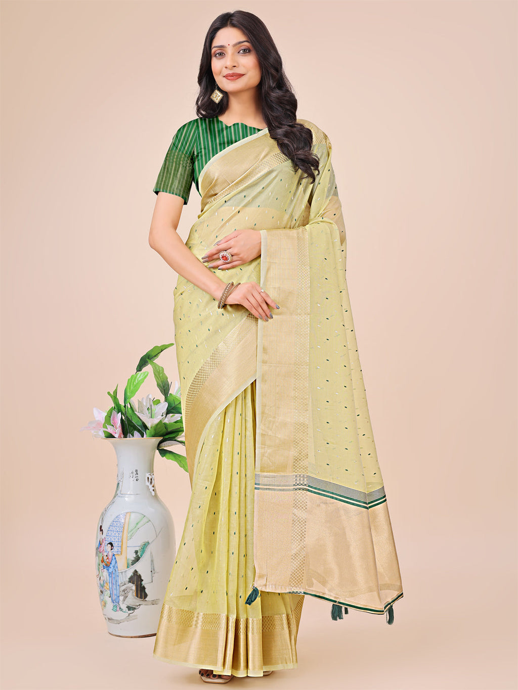 Light green organza silk saree with woven patterns and golden border