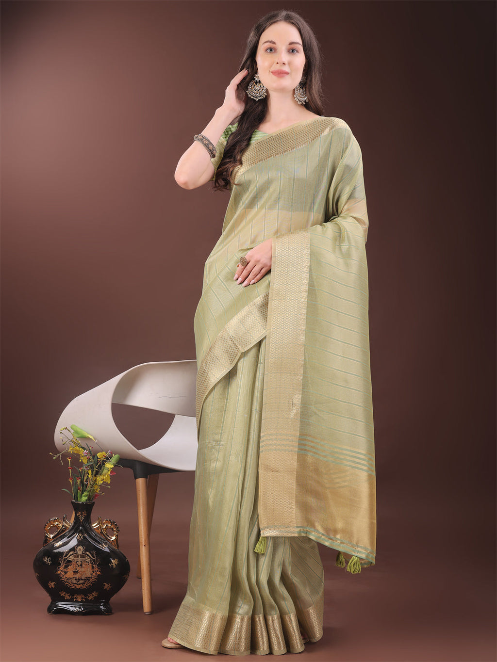 Gold mint green organza saree with golden zari border and matching blouse piece