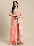 Elegant peach linen saree with contrast zari border and tassels draped gracefully