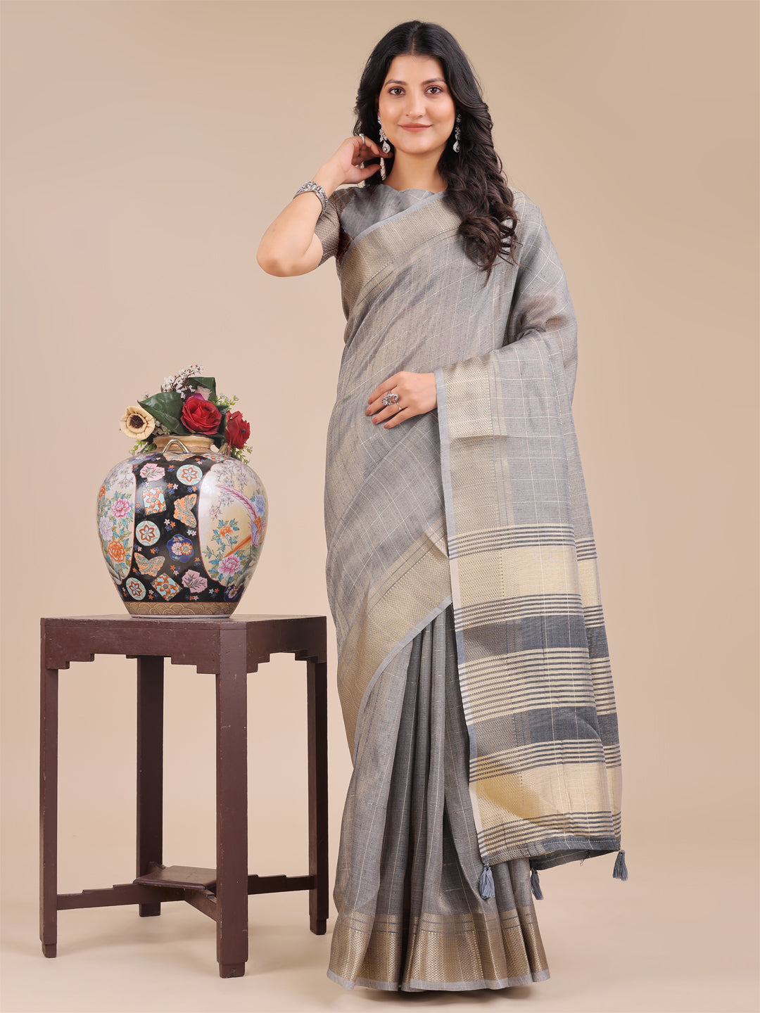 Grey organza saree with woven zari work and decorative tassels