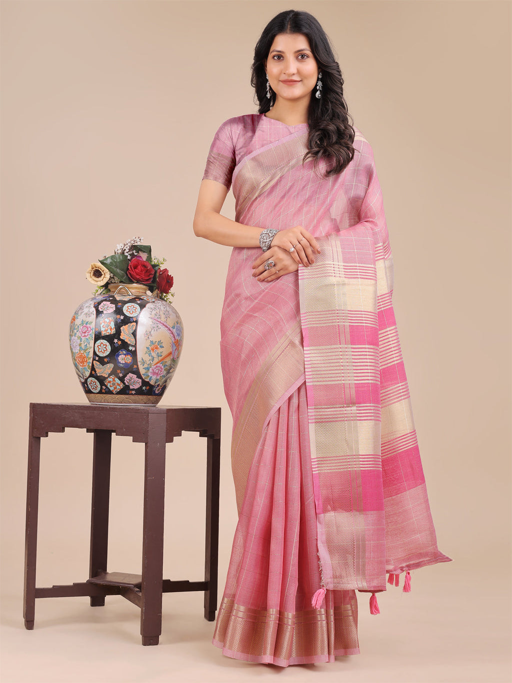 Pink Organza saree with woven zari borders and decorative tassels