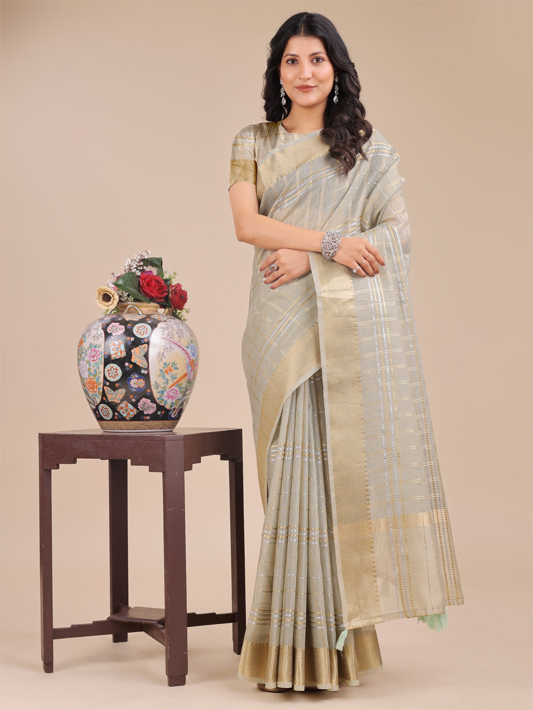 Beige Organza saree with woven gold zari work and traditional tassels
