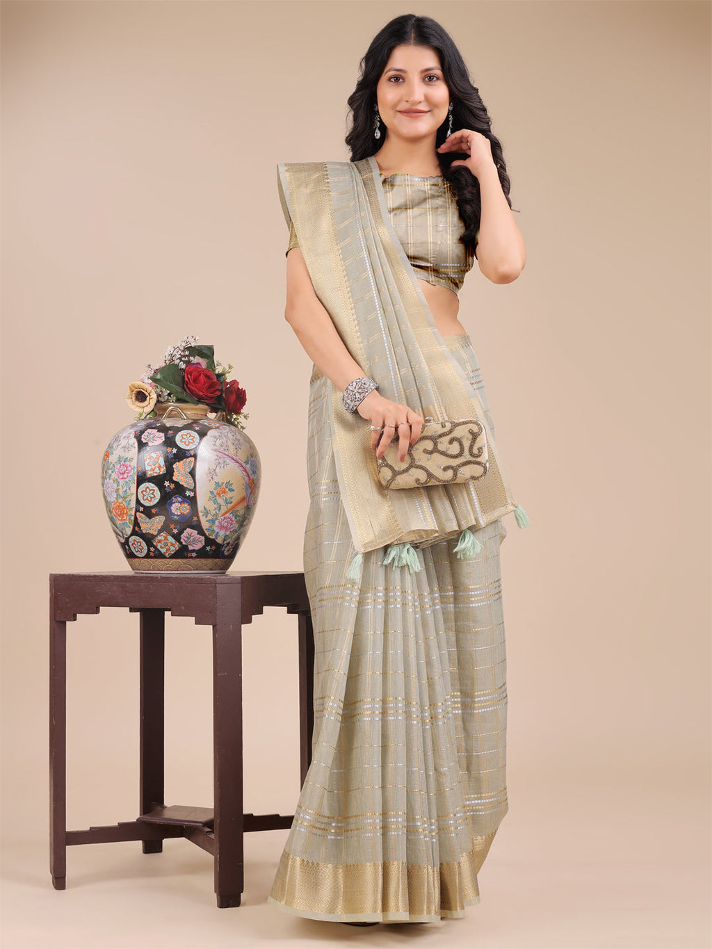 Beige Organza Saree with Woven Zari Work and Traditional Tassels