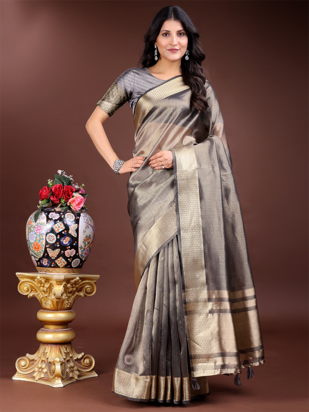 Grey Organza saree featuring intricate woven zari work and traditional tassel detailing