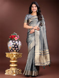 Silver-toned organza saree decorated with intricate zari patterns and tassels.