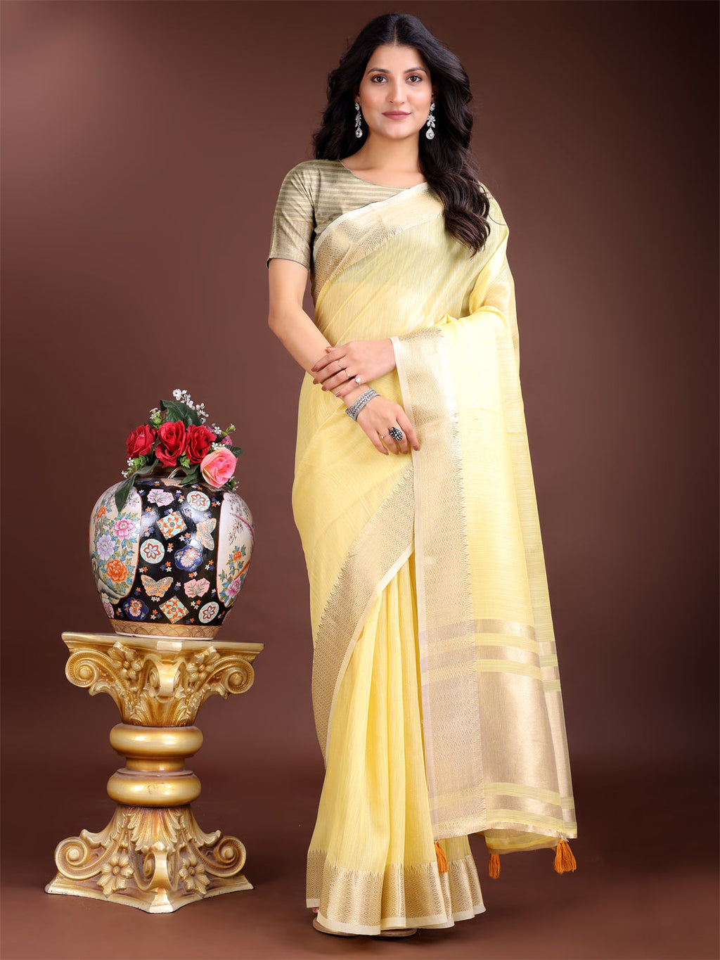 Yellow linen saree with contrast zari border and decorative tassels