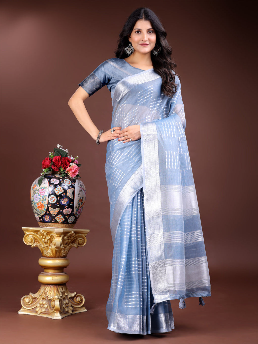 Sky blue organza saree with woven zari work and traditional tassels