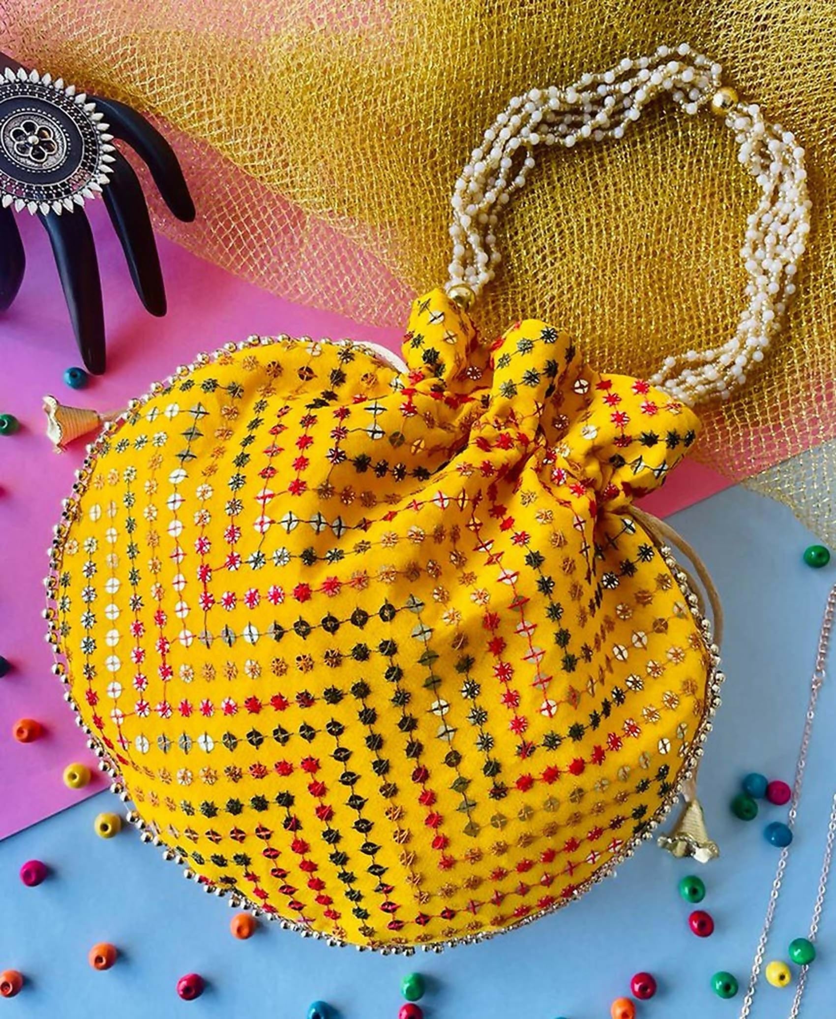 Yellow bohemian style potli bag for women with geometric pattern