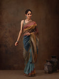 Woman wearing a multicolor silk blend striped saree with digital print in earthy tones of blue, mustard, and clay