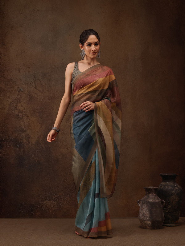 Woman wearing a multicolor silk blend striped saree with digital print in earthy tones of blue, mustard, and clay