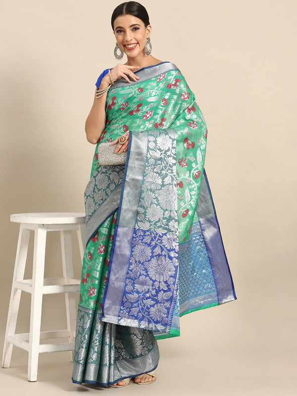 Turquoise brocade saree with detailed woven zari floral patterns and unstitched blouse piece.