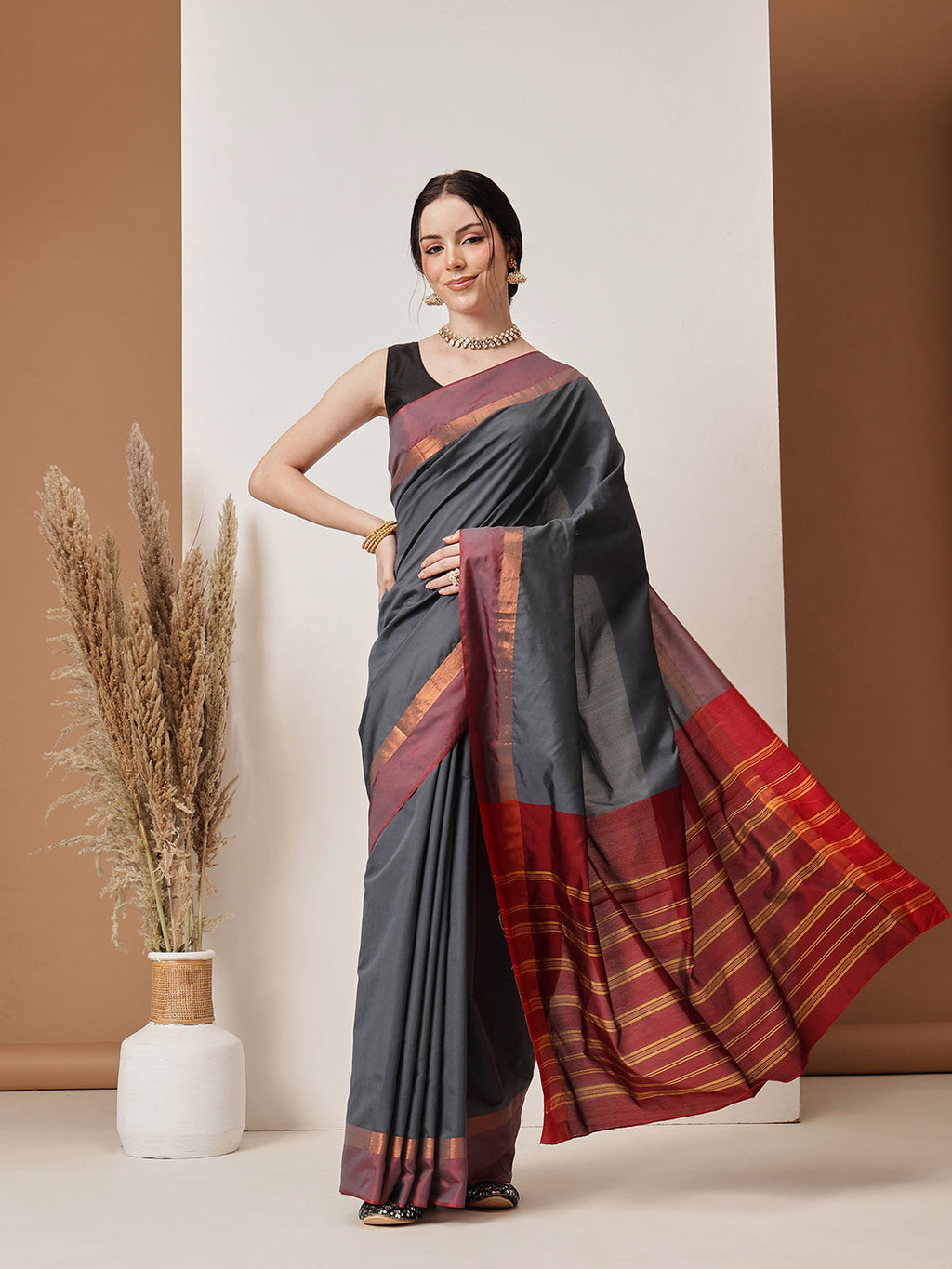 Model wearing a solid grey Banarasi art silk saree with elegant drape