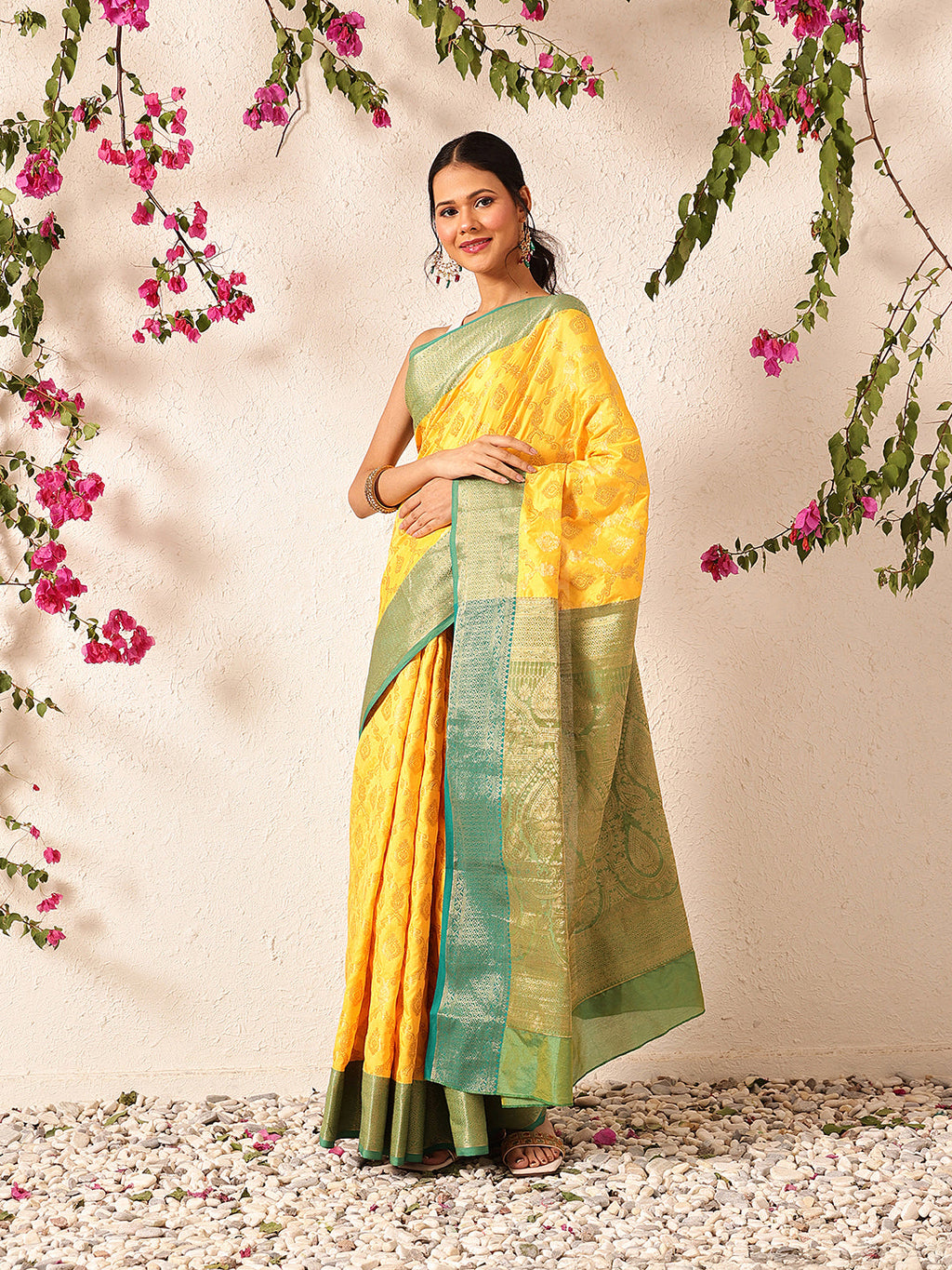 Vibrant yellow Banarasi silk saree with intricate woven traditional patterns.