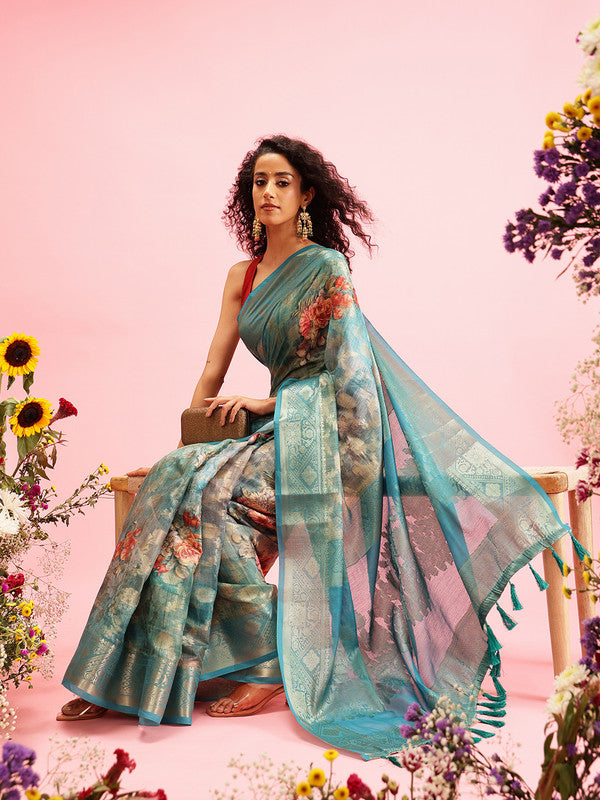 Turquoise floral print cotton saree accompanied by an unstitched blouse piece.