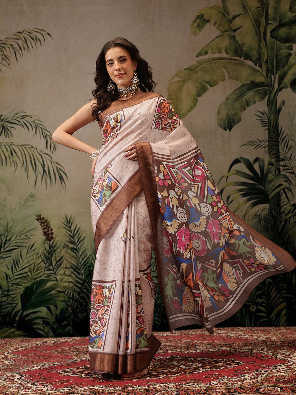 Woman wearing a dusty pink Banarasi silk blend saree with dark brown borders and vibrant floral digital prints