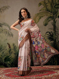 Woman wearing a dusty pink Banarasi silk blend saree with dark brown borders and vibrant floral digital prints