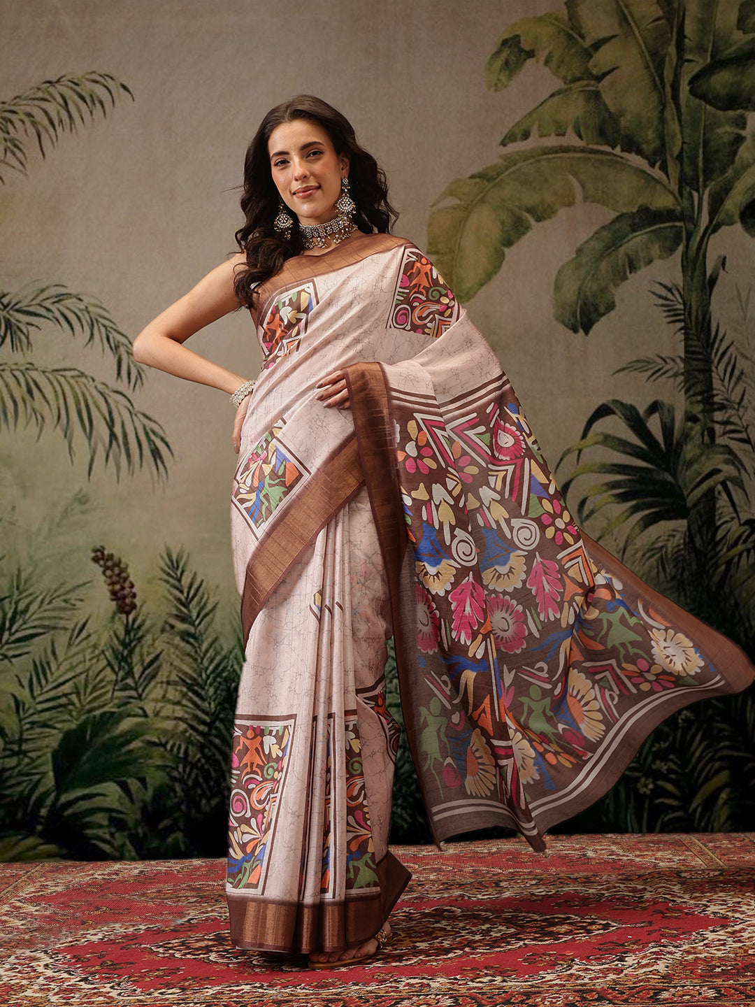 Woman wearing a dusty pink Banarasi silk blend saree with dark brown borders and vibrant floral digital prints