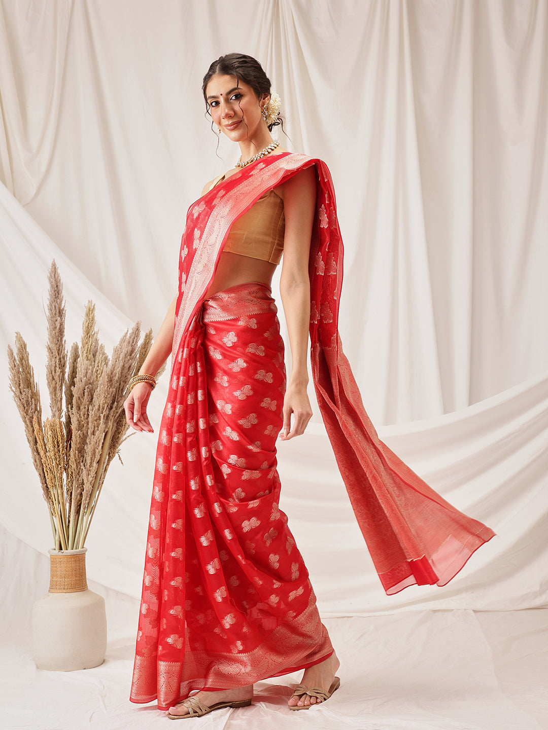 Stunning red Banarasi organza silk saree featuring woven abstract patterns
