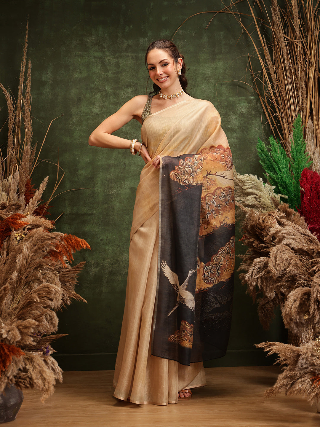Beige cotton tissue saree with delicate floral digital prints draped elegantly.