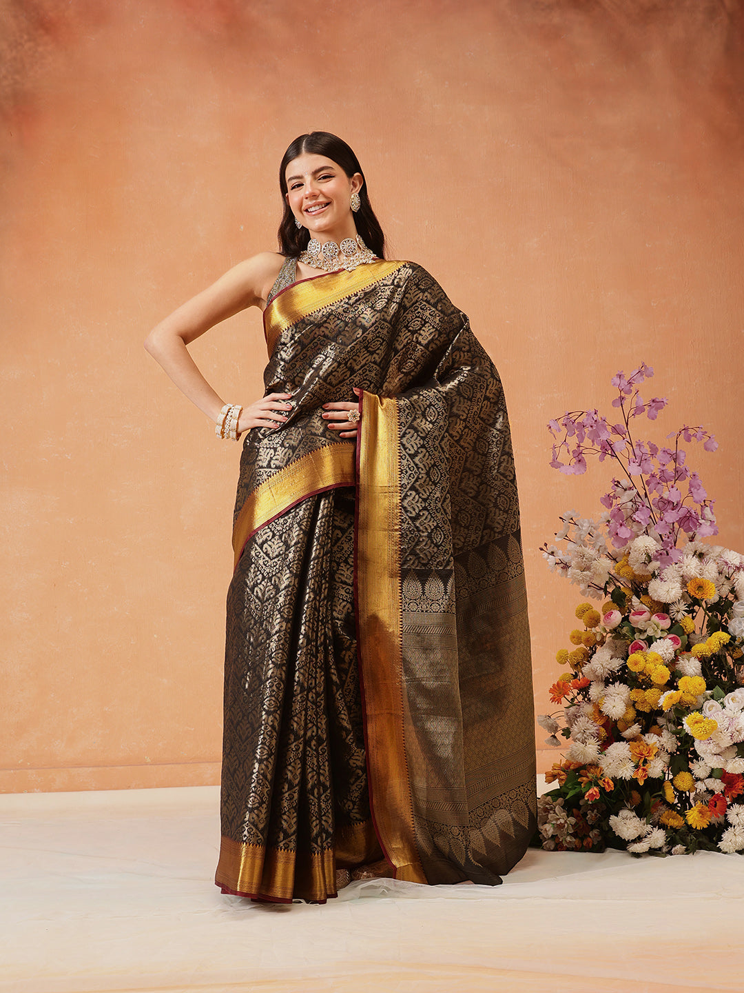 Black Kanjeevaram Banarasi silk saree featuring traditional Ikkat woven patterns.