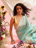 Turquoise linen saree with woven thread floral motifs and matching unstitched blouse
