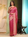 Vibrant pink Banarasi art silk saree featuring gold zari striped patterns