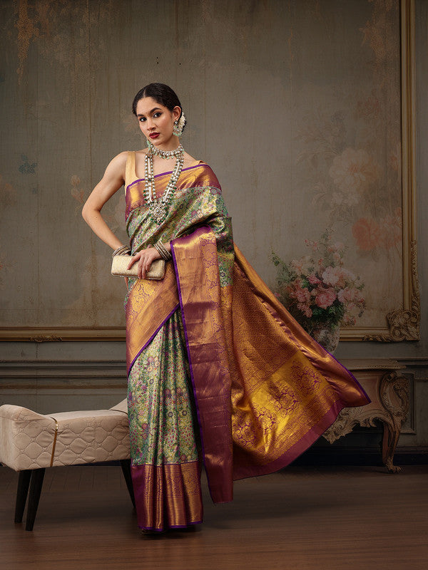 Elegant green pure silk saree with woven zari floral design and unstitched blouse piece.