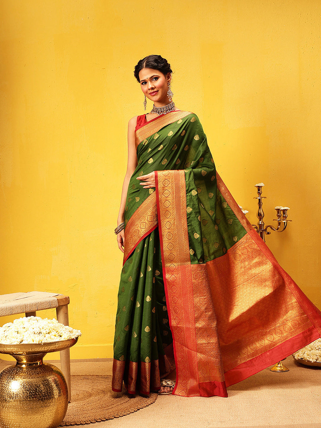 A beautiful green Kanjeevaram silk saree with intricate gold woven detailing, elegant traditional Indian attire.