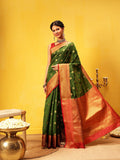 A beautiful green Kanjeevaram silk saree with intricate gold woven detailing, elegant traditional Indian attire.