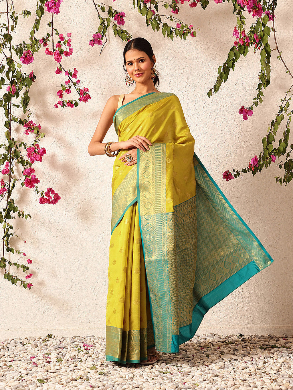 A bright yellow Kanjeevaram silk saree with intricate woven patterns, perfect for traditional events.