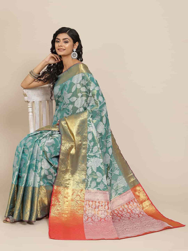 Turquoise pure silk saree with detailed floral embellishments and unstitched blouse