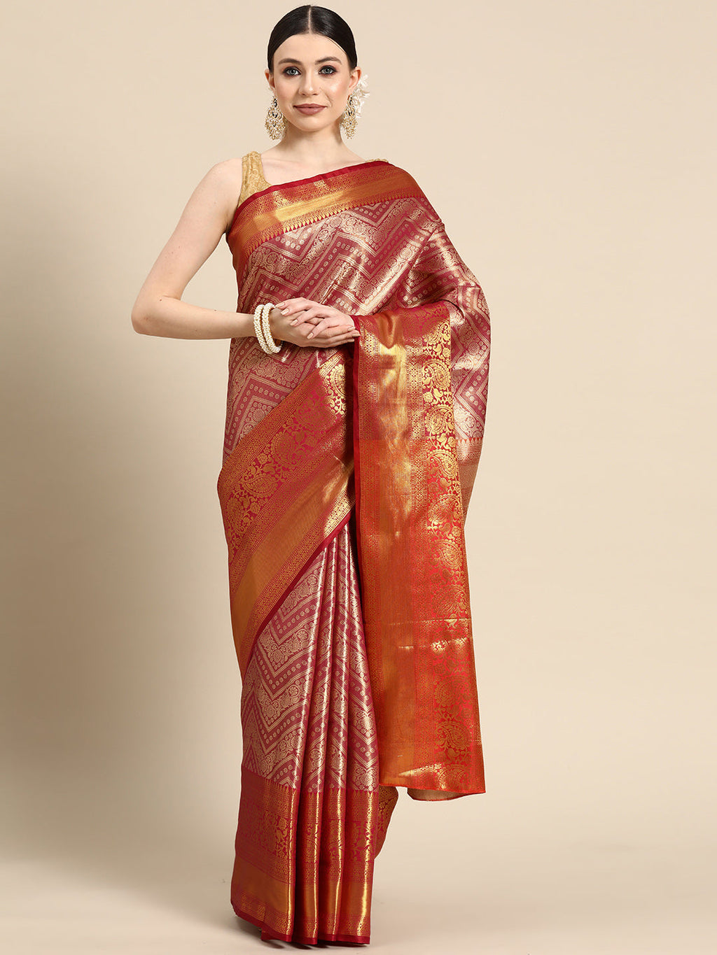 Pink brocade saree with intricate woven zari stripes and an unstitched blouse piece.