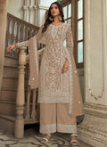 Beige premium net palazzo suit with delicate embroidery and classic A-line cut.