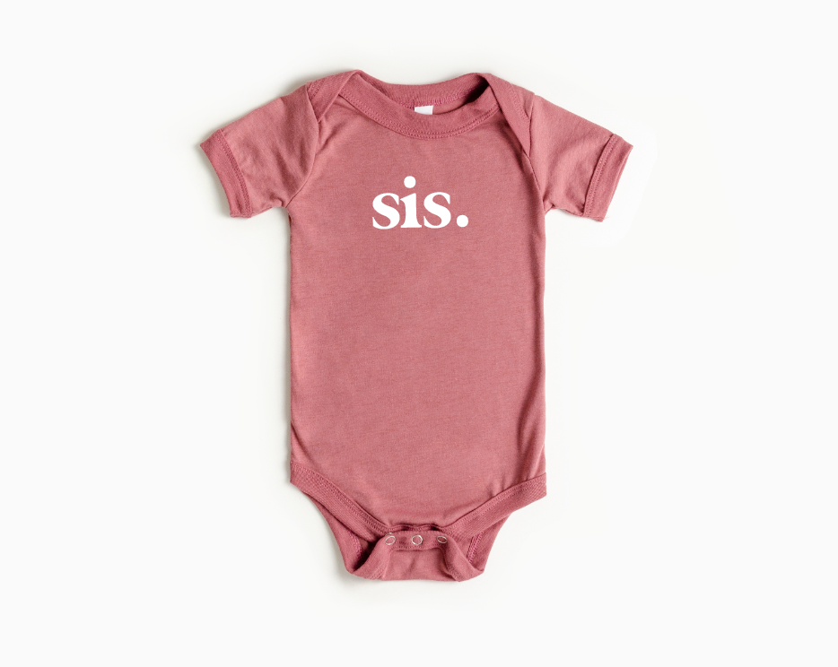 Minimalist baby onesie in solid dusty rose color with snap leg closures.