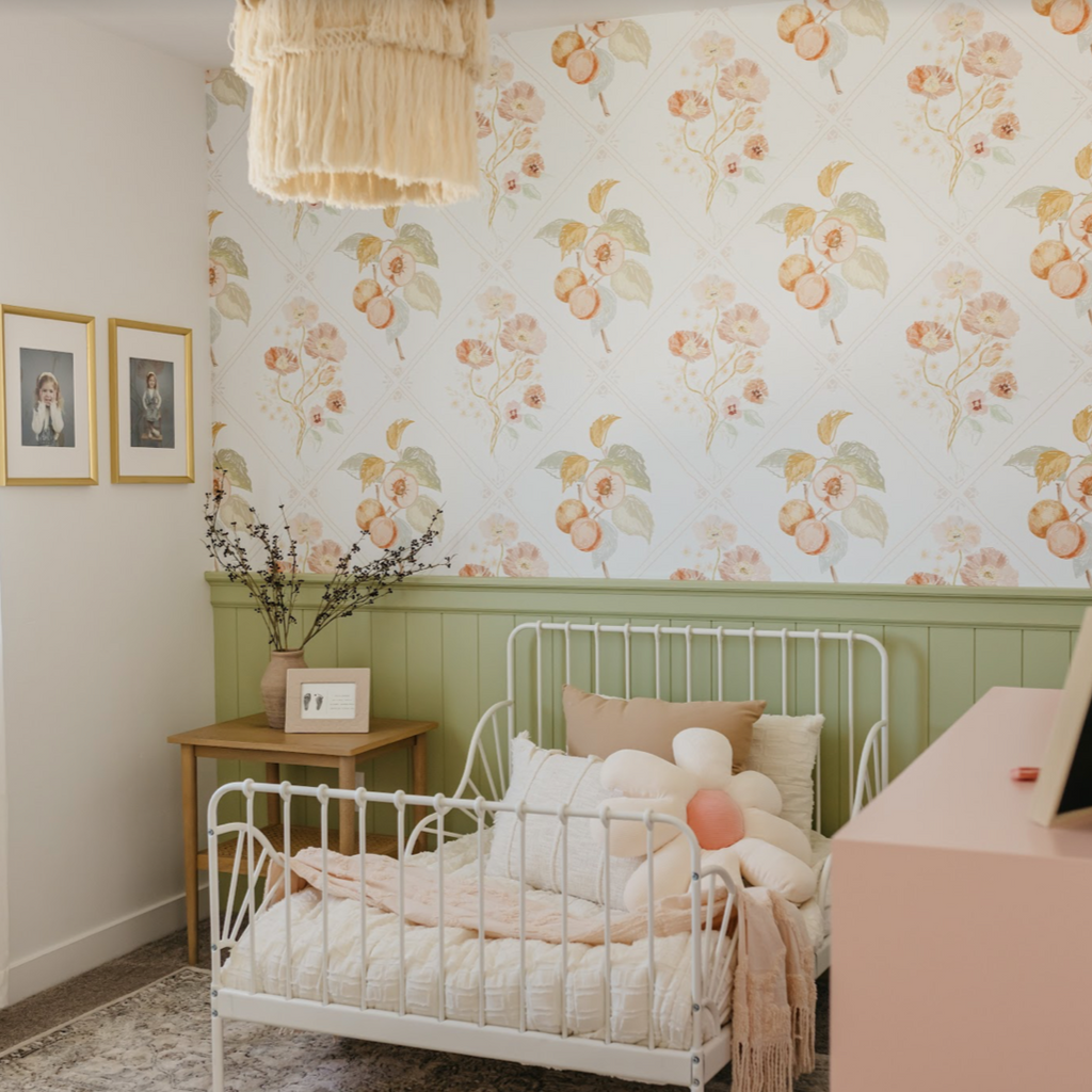 Ingrid floral wallpaper featuring white, peach, and sage-green botanical details