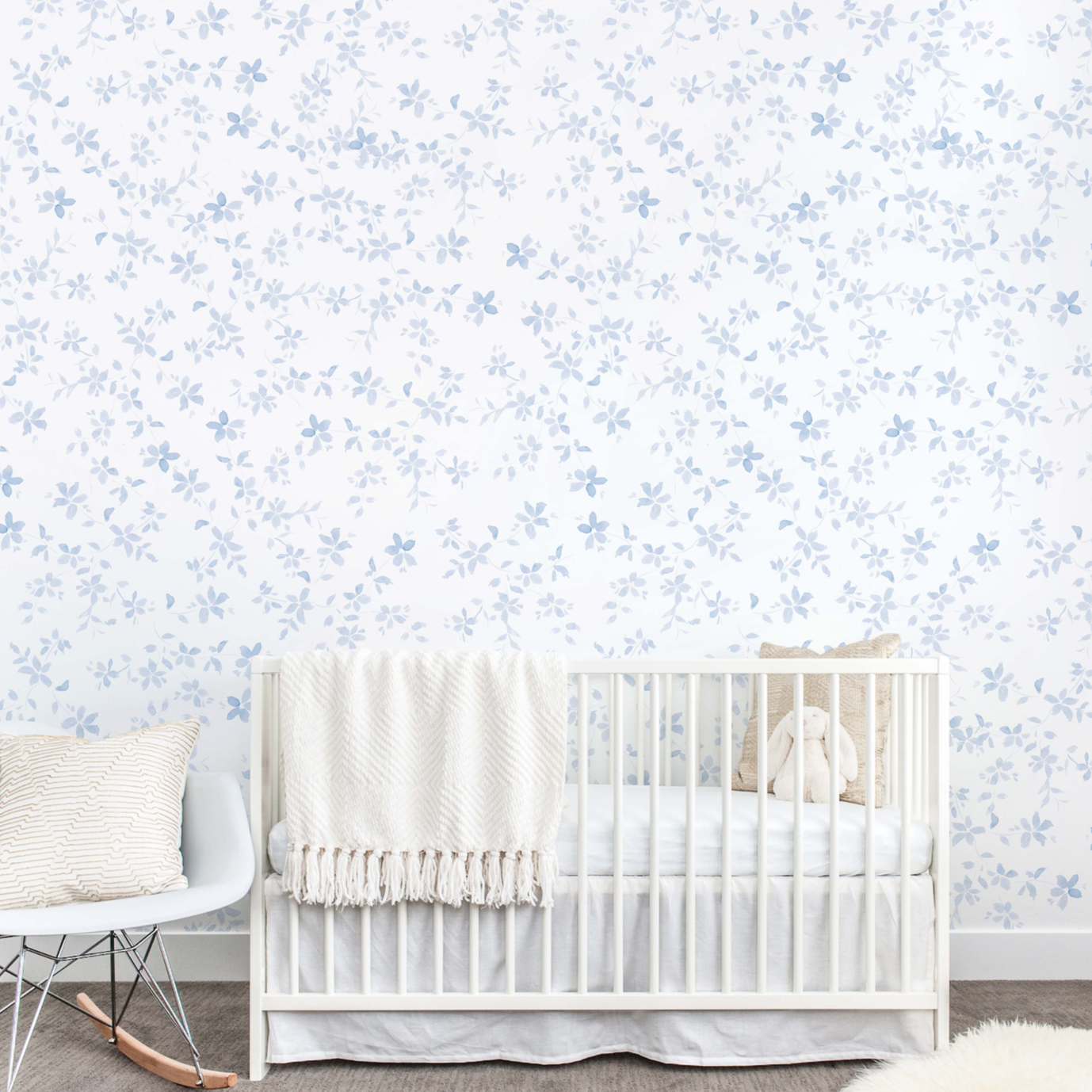 Ida floral wallpaper with blue, white, and pink flowers on a light background.