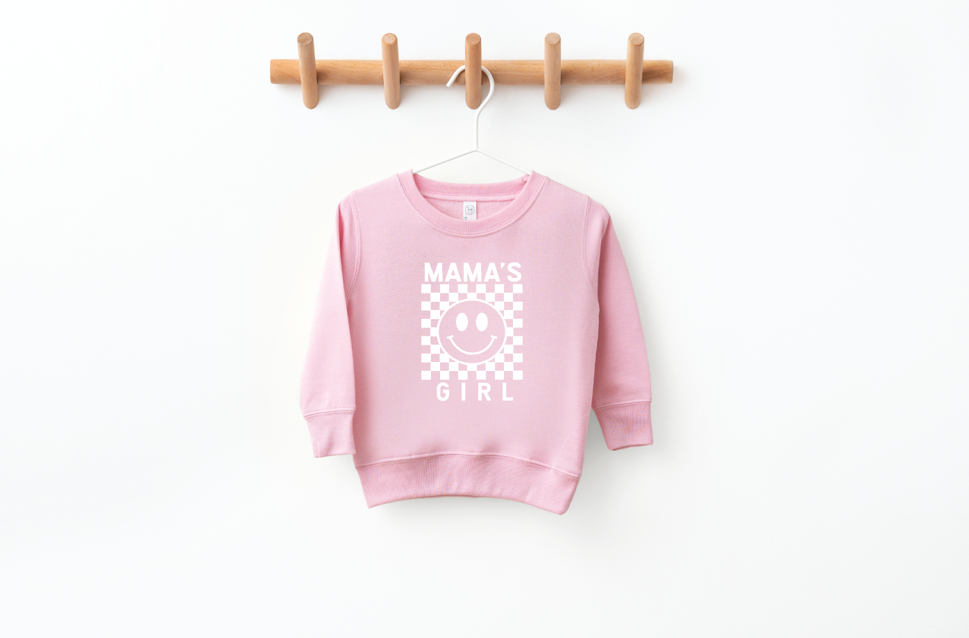 Toddler wearing a Mama's Girl long sleeve checkered pullover top in soft knit fabric.