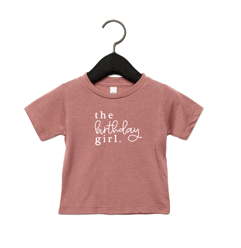 Girl wearing a minimalist The Birthday Girl graphic t-shirt