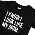 Child wearing a grey graphic t-shirt that reads I know I look like my mom